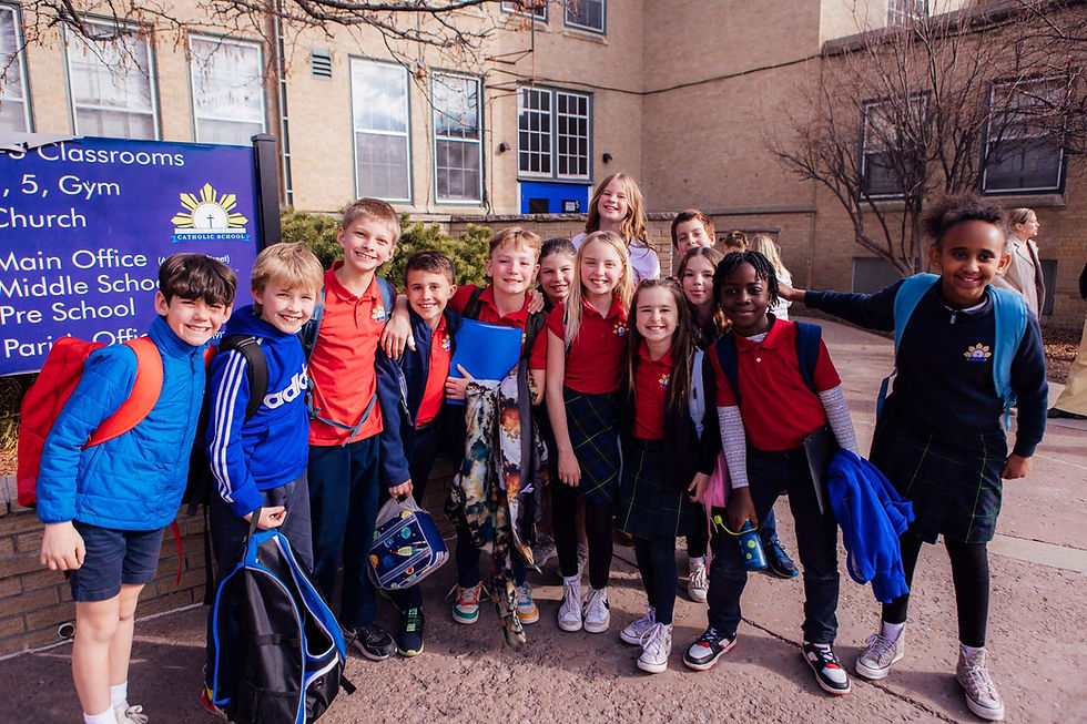 A group of kids smiling at Blessed Sacrament School in Denver, CO