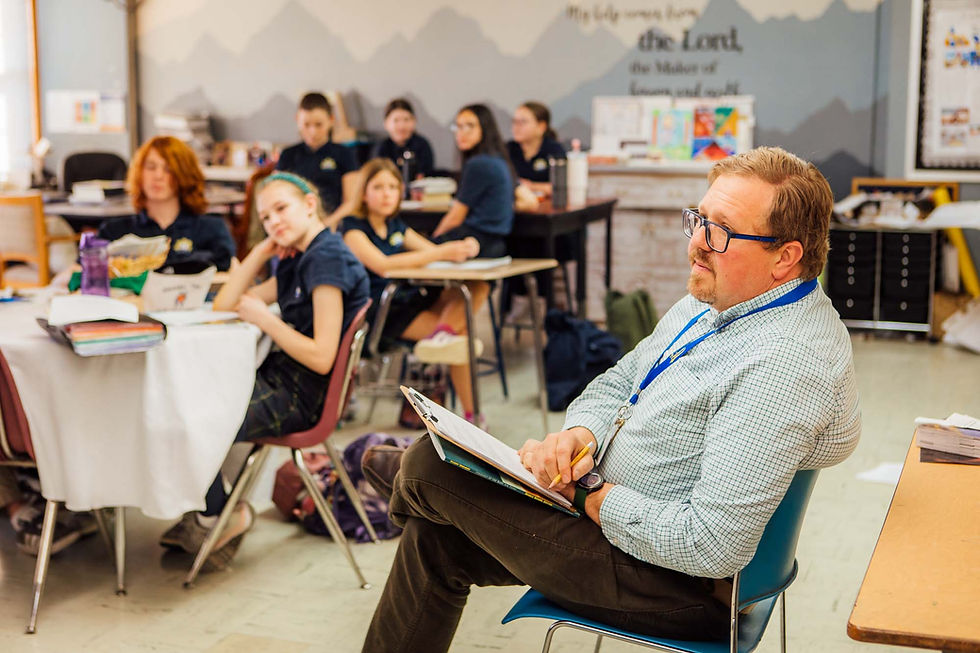 A teacher observing class at Blessed Sacrament Catholic School in Denver, CO