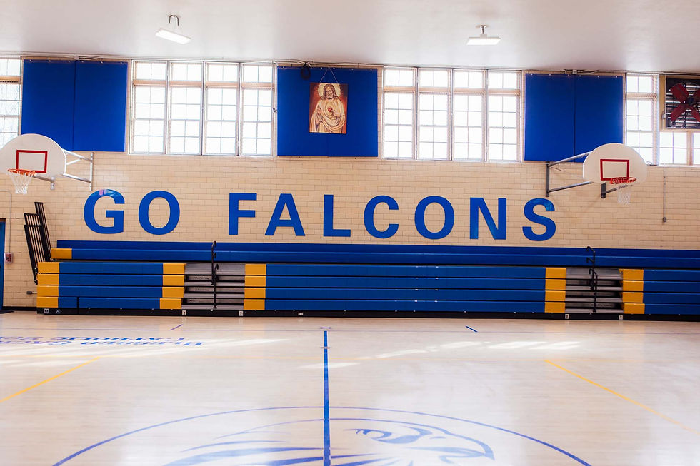 A beige gym with blue accents that says "Go Falcons" and a photo of Jesus on the top