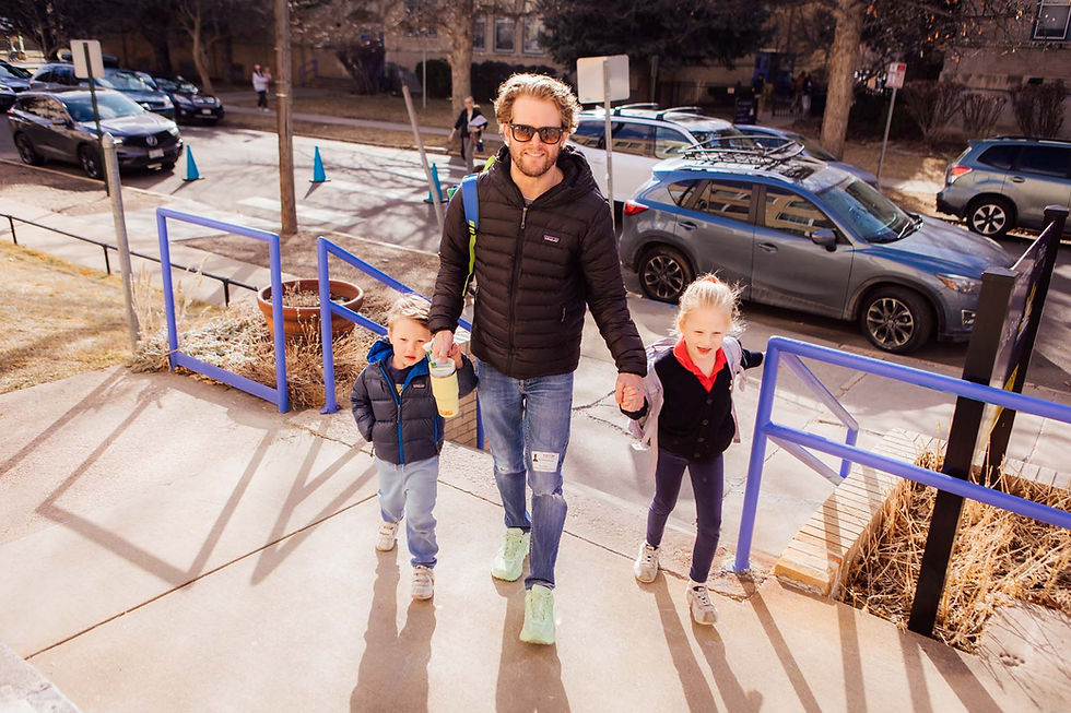 A dad walking his kids into school at Blessed Sacrament Catholic School in Denver, CO