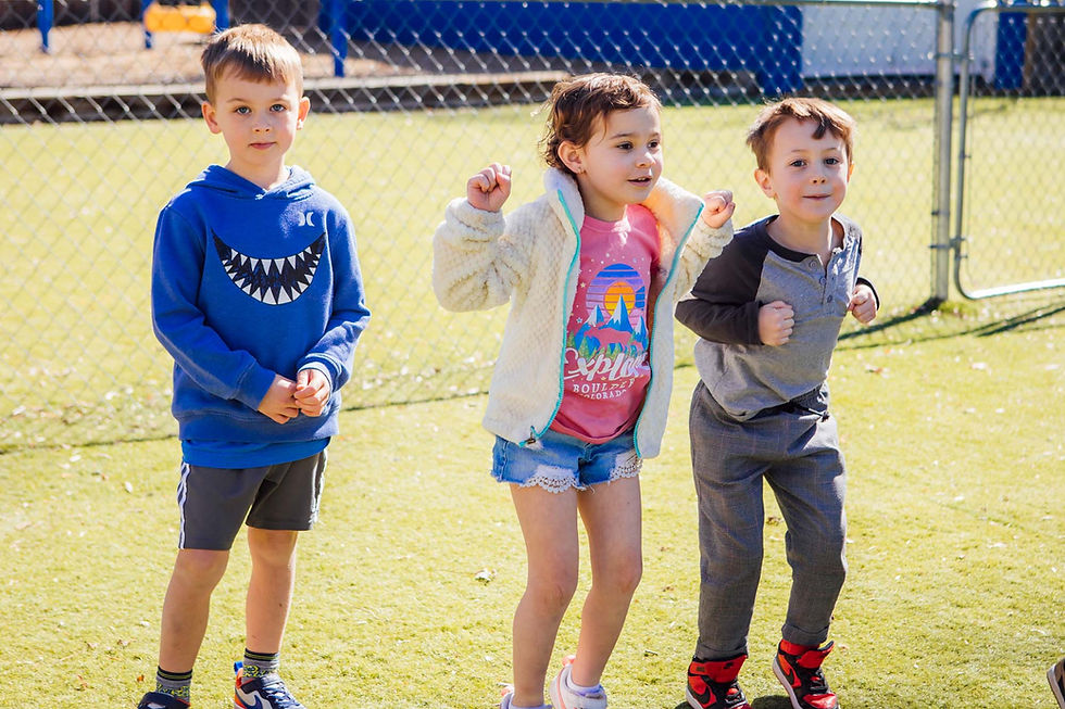 A group of young children playing outside