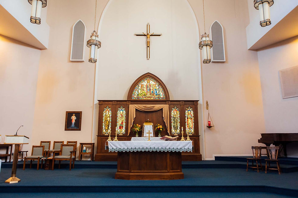 A Catholic Church with a brown altar and white walls
