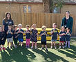 A gropu of preschool students wearing navy blue t-shirts