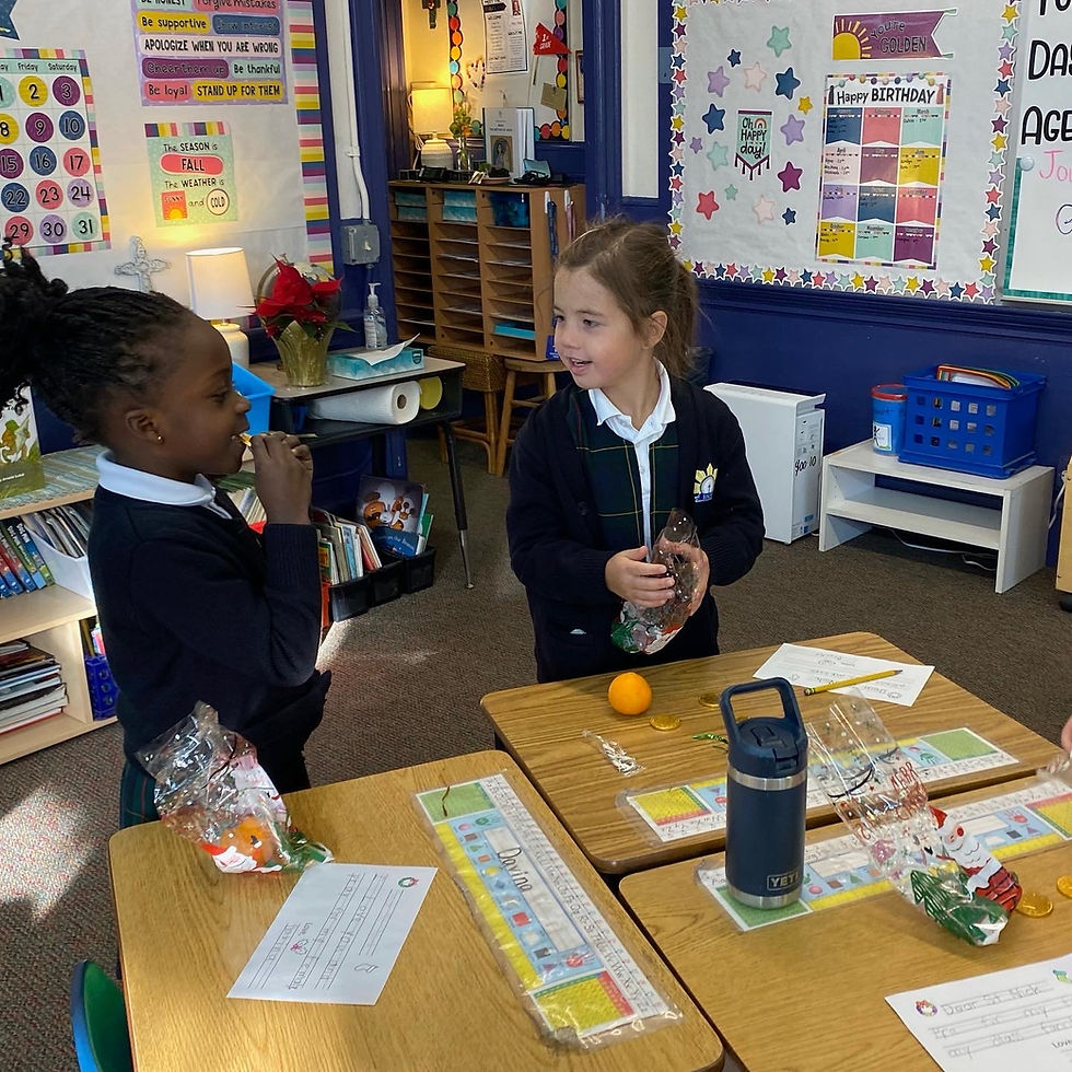 Two girls working together at Blessed Sacrament School in Denver, Co