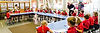 A group of students in red uniforms gathered around their desks